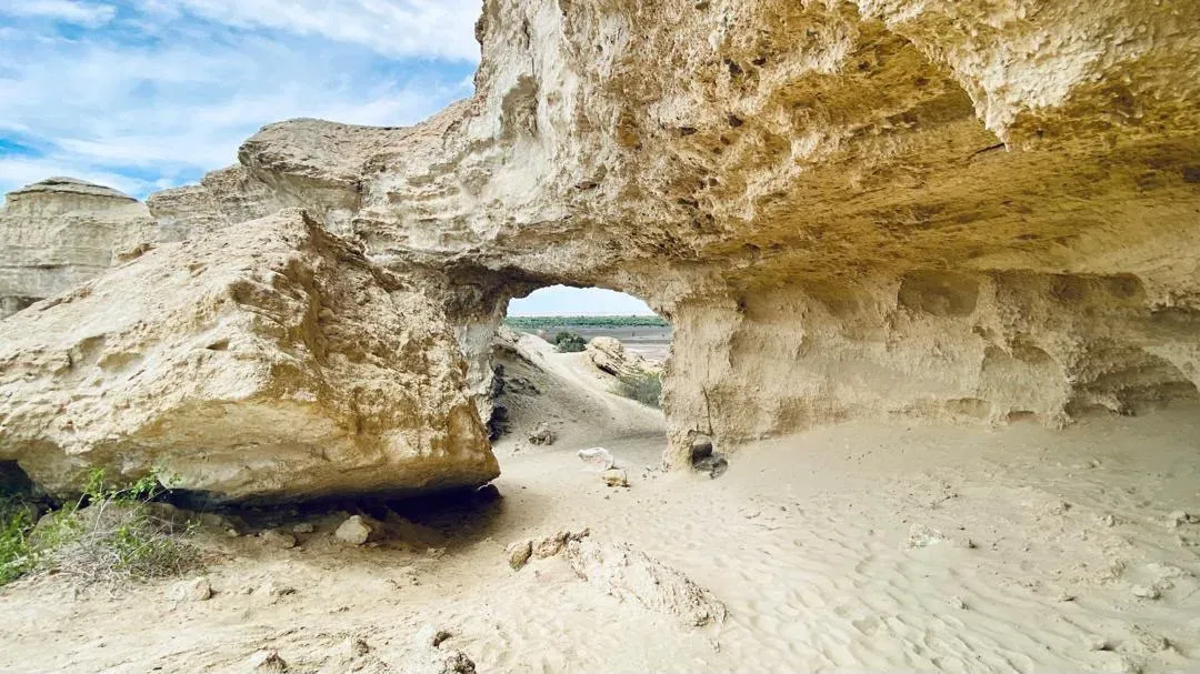 Sculpted rock frames the Arco's lagoon in the Namibe desert