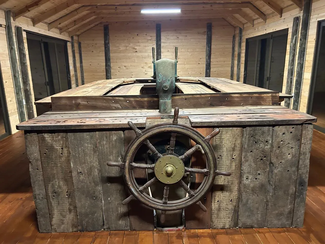 A salvaged ship's wheel and wreck timber inside Meob Lodge
