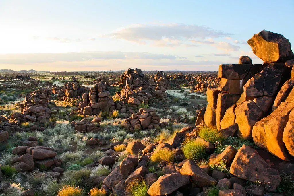Balancing dolerite towers glow at golden hour in the Giant's Playground