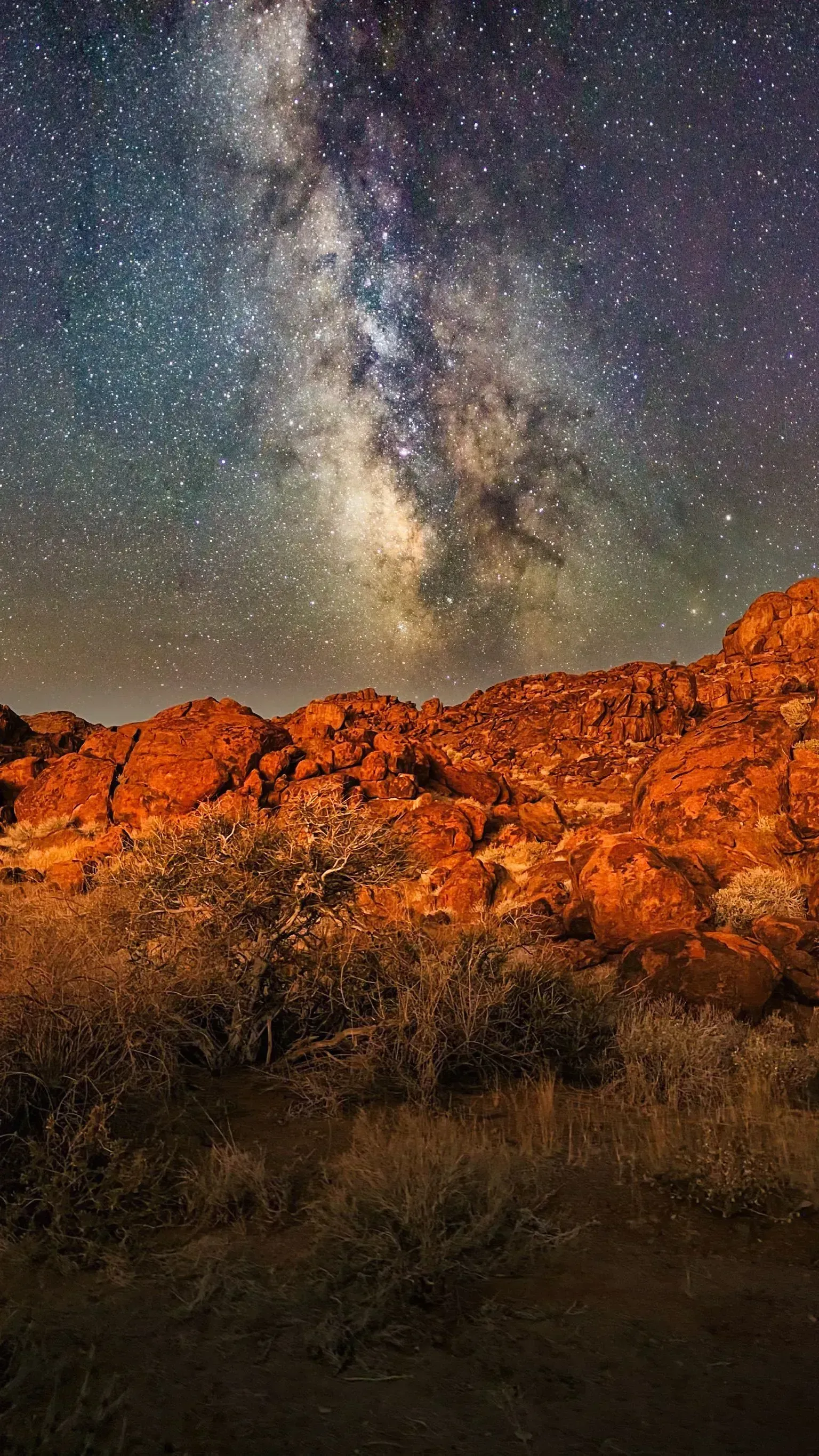 The Milky Way blazes over the granite boulders