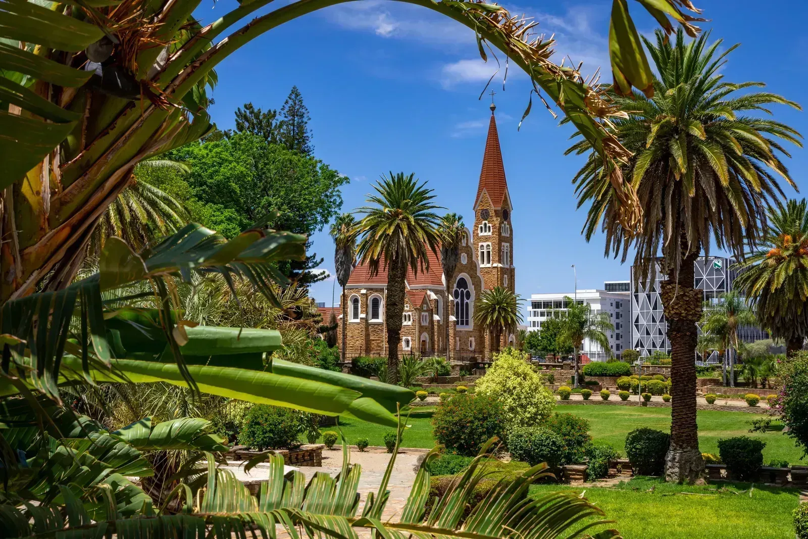 The sandstone Christuskirche framed by palms in the Parliament Gardens